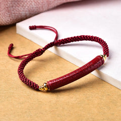 Cinnabar Heart Sutra Blessing Bracelet – side view showing engraved text with gold spacer beads, Buddhist bracelet