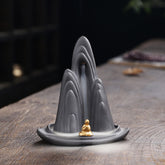 Little Monk Purple Clay Backflow Incense Burner - Gray mountain with gold monk and smoke waterfall, backflow incense