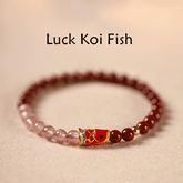 Cinnabar Strawberry Quartz Koi Fish Bracelet – red and pink beads with koi, low angle, blessing