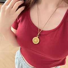 Om Mani Padme Hum Pendant – Worn on model with burgundy top showcasing layered necklace length, mantra jewelry