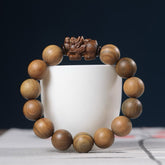 Green Sandalwood Pixiu Attract Wealth Bracelet – front dark navy carved pixiu beads, Prosperous