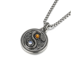 Snake Yin Yang Necklace - Silver yin-yang serpent medallion with orange and blue gemstones, three-quarter view, spiritual jew