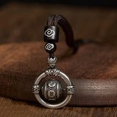Om Mani Padme Hum Pendant – Front close-up of rotating drum with engraved mantra on dark leather, Buddhist jewelry