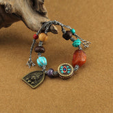 Tibetan Zakiram Turquoise Lotus Rope Bracelet – cord bracelet with turquoise and amber beads draped on driftwood, Boho
