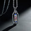 Om Mani Padme Hum Prayer Wheel Pendant – Three-quarter view of prayer wheel with blue and red enamel bands on rope chain, ...