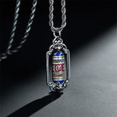 Om Mani Padme Hum Prayer Wheel Pendant – Three-quarter view of prayer wheel with blue and red enamel bands on rope chain, ...