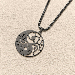 Yin Yang Branches Necklace – Dark gunmetal close-up on neutral textured bg, balance necklace