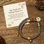 Zakiram Om Mani Padme Hum String Bracelet – multicolor braided cord with gold charms on rustic wood, Tibetan bracelet