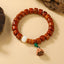 Bone Beads Lotus Peace Buckle Enlightenment Bracelet – lotus seed pod pendant dangling from green bead, handcrafted