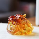 Handmade Liuli Crystal Gold Swallowing Pixiu – Amber liuli Pixiu with gold ingots in mouth, side view, feng shui decor