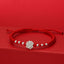 Sterling Silver Lotus Red String Luck Bracelet – silver lotus charm with symmetrical beads on woven red cord, spiritual