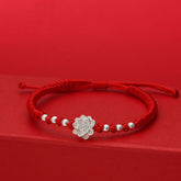 Sterling Silver Lotus Red String Luck Bracelet – silver lotus charm with symmetrical beads on woven red cord, spiritual