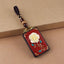 Ebony Koi Fish Fu Character Keychain – single red lacquer rose pendant with gold stem and turquoise inlay on kraft paper