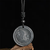 Natural Shungite Carved Yin Yang Pendant - front view on black backdrop, shungite necklace