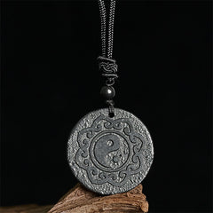 Shungite Yin Yang Pendant – close-up on black backdrop, carved yin yang talisman