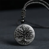 Tree of Life Black Obsidian Necklace – round pendant with engraved tree detail on gray cord, spiritual jewelry