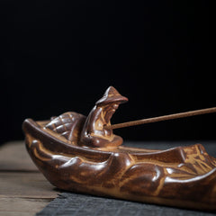 Boat Cicada Ceramic Incense Burner – Side profile of ceramic boat with fisherman on black background, artisan