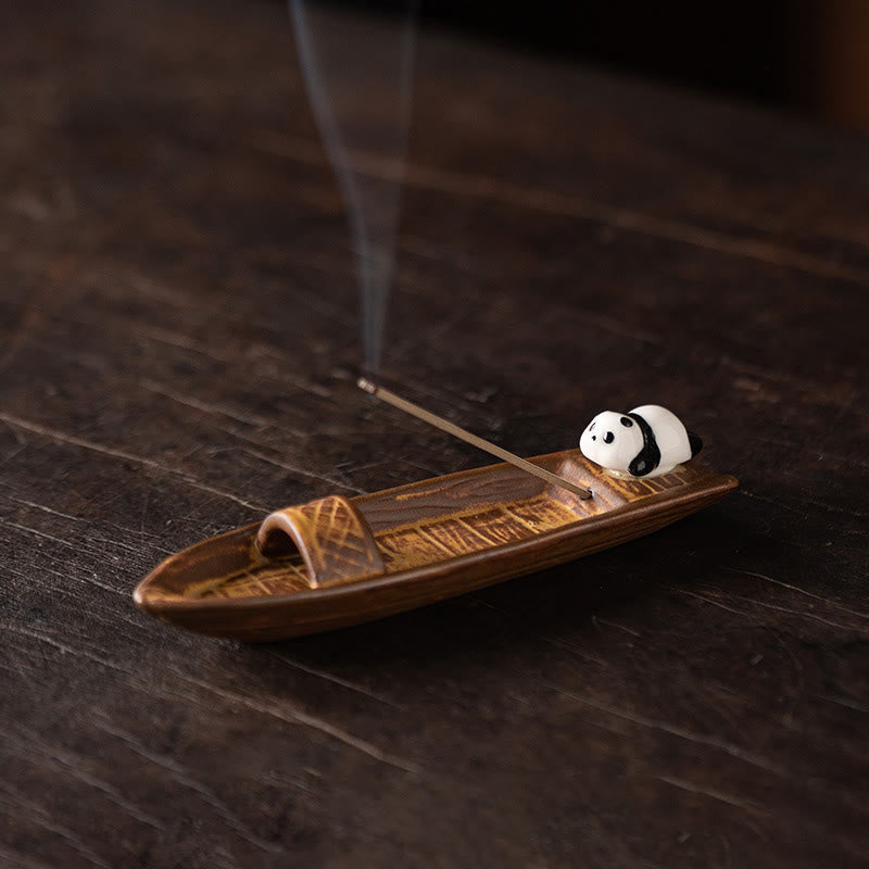 Panda Ceramic Incense Burner - Panda on brown boat with smoke on dark wood, ceramic incense burner