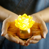Lotus Liuli Glass Decoration held in hands glowing golden, liuli decor