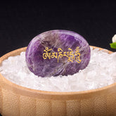 Om Mani Padme Hum Palm Stone – Purple amethyst with gold mantra engraving in crystal bed
