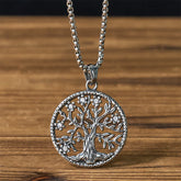 Tree of Life Titanium Steel Necklace – Silver pendant with crystal accents on box chain, wooden background