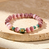 Purple Cat’s Eye Lotus Enlightenment Bracelet – Pink cat’s eye beads with gold lotus charm on green jade centerpiece, spiritual bracelet