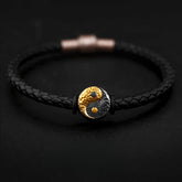 Yin Yang Bagua Leather Bracelet - Black braided leather with gold yin yang charm on dark background, yin yang jewelry