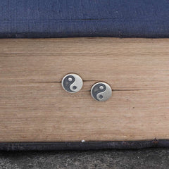 Yin Yang Stud Earrings - Flat lay pair on wood and fabric, antique silver finish, zen jewelry
