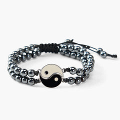 Hematite Lava Rock Yin Yang Bracelet - Double-row black bead bracelet with yin-yang charm on white background