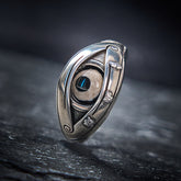 Dzi Evil Eye Ring – Antiqued silver eye ring with blue pupil stone on dark slate, protection ring