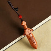 Yin Yang Sword Keychain - Hand-carved peach wood sword with yin-yang symbol and Taoist characters, red agate bead on braided