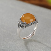 Vintage Silver Honey Amber Ring – Oval amber cabochon in ornate floral silver setting on gray linen, bohemian ring