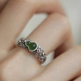 Jade Gourd Ring – green jade gourd set in carved silver band with auspicious cloud patterns, worn on finger close-up, health jewelry