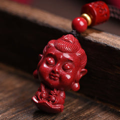 Chinese Zodiac Cinnabar Pendant – Intricate Buddha carving in meditation mudra on dark wood, amulet jewelry