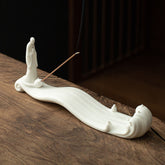 Buddha Monk Sea Wave Mountain Ceramic Incense Burner – White monk figure on flowing wave base with burning incense smoke, ceramic incense burner