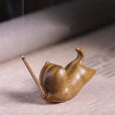 Green Sandalwood Cat Incense Burner - Reclining cat with lit incense smoke, soothing decor