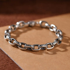 Om Mani Padme Hum Silver Bracelet – Close-up of alternating oval and bar links with Tibetan script engravings, oxidized finish