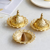 Tibetan Gold Mini Meditation Incense Burner – Three gold burners on marble, one open with cone, pierced dome lids