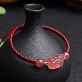 Strawberry Quartz PiXiu Red Bracelet – pink PiXiu beads red cord over black vase, love luck red string