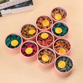 Tibetan incense cones – ten pink tubes of colorful meditation cones with yellow holders on wood, calming