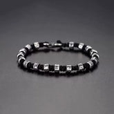 Zen Mantra Cord Bracelet – silver engraved mantra beads on black braided cord with S-hook clasp, dark gray background, mindfulness jewelry