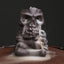 Skull Head Purple Clay Incense Burner – smoke cascading from eye sockets over woven mat, backflow incense