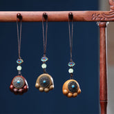 Sandalwood Om Mani Padme Hum Lucky Cat Paw Phone Charm - Three wood tone variants, navy backdrop
