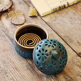 Mini Ceramic Incense Burner - Open lid revealing coiled incense, dried leaves, zen meditation setup