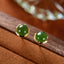 Hetian Cyan Jade Gold Plated Silver Stud Earrings on brown wood