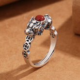 PiXiu Copper Coin Red Agate Ring three-quarter view on kraft paper, silver beast motif, adjustable band, luck
