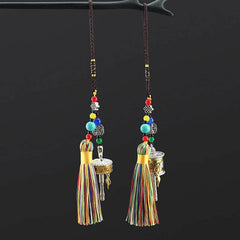 Tibetan Prayer Wheel Tassel – Matching prayer wheel ornaments with multicolored beads on black background