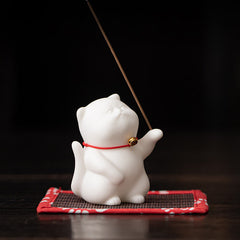 Mini Cute Cat Ceramic Incense Burner – Side view of white cat figurine on woven mat with incense stick, meditation decor