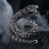 Dragon Snake Copper Bracelet – Articulated dragon cuff with blue gemstone eye on smoky dark background, Powerful