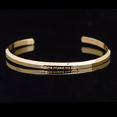 Om Mani Padme Hum Engraved Bracelet – gold cuff with mantra text on black background, spiritual bangle